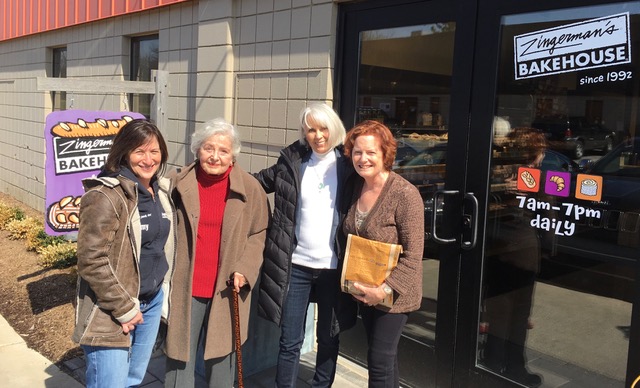 A group of women
                                            standing outside a building
                                            Description automatically
                                            generated